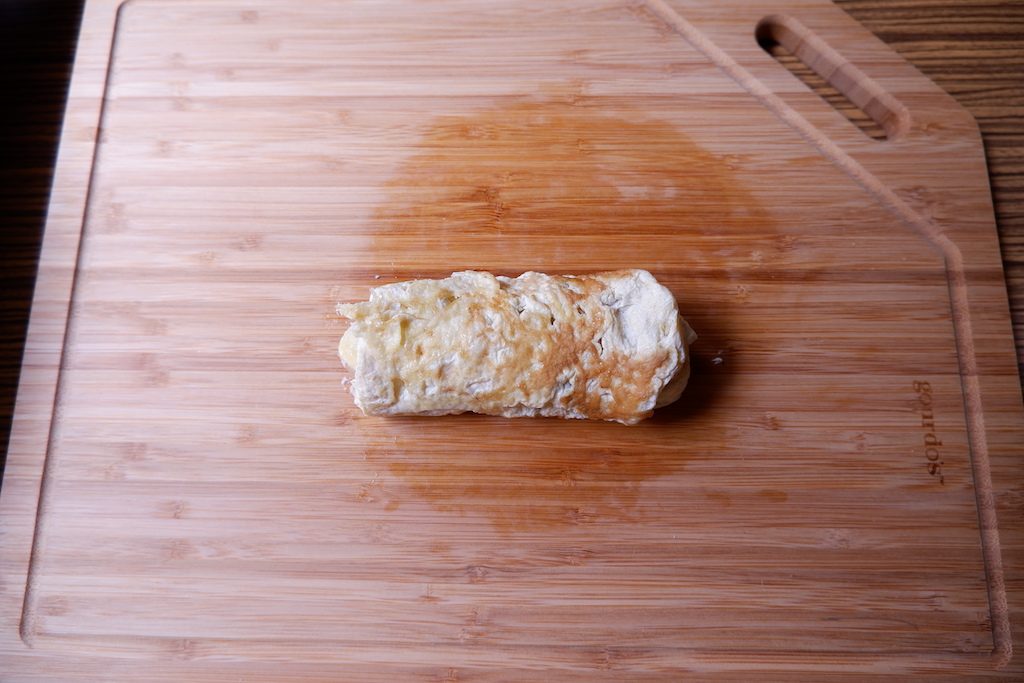 carefully wrap keto breakfast crepe like a burrito