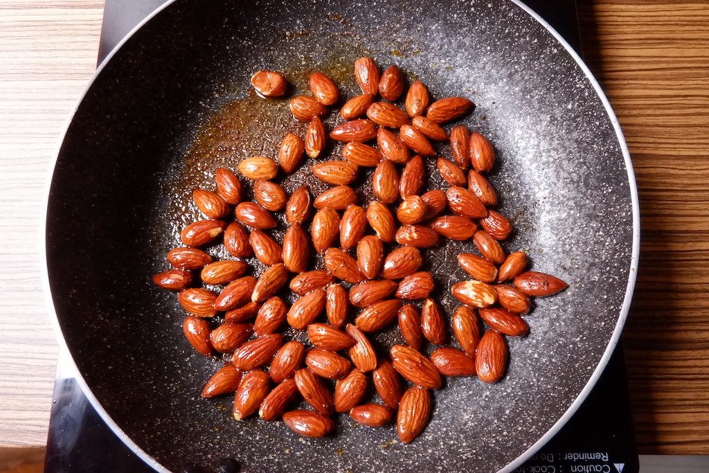 Roast almonds until golden brown in color